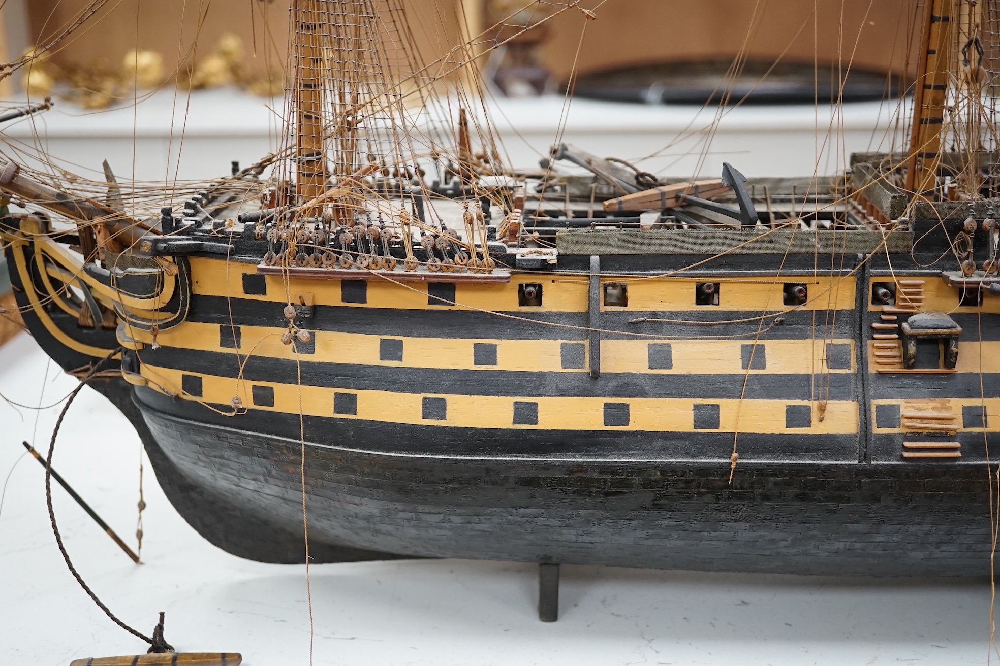 A large model of a rigged ship, 84cm long. Condition - fair